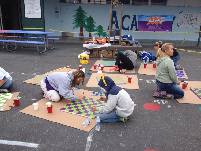 Painting checkerboards for the picnic tables.